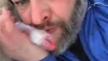 Bearded zoophile blowing his dog in the snow