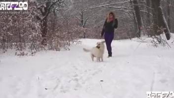 Beautiful blonde has sex with white dog in the forest