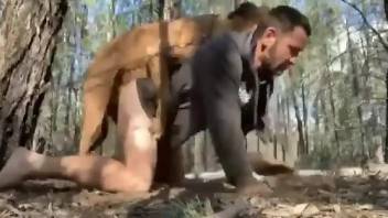 Half naked man bends ass for dog's cock in outdoor zoophilia