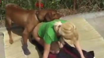Blonde in green making love with a horny brown beast